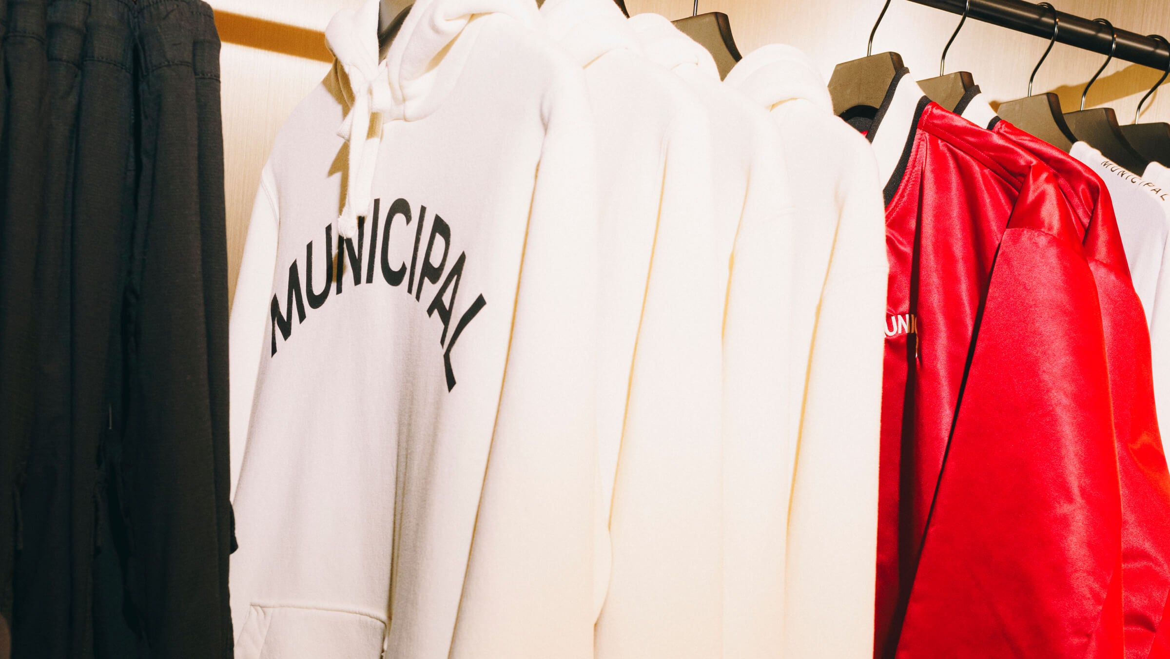 MUNICIPAL hoodies on clothing rack